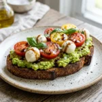 Delicious Caprese avocado toast with mozzarella, tomatoes, and basil.